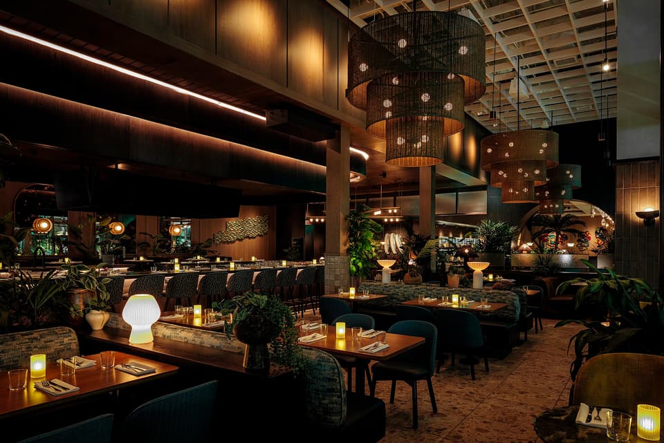 A restaurant dining room set for evening service